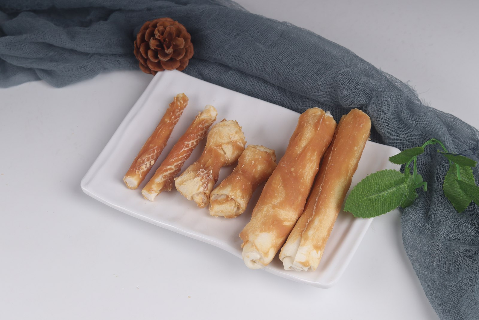 Chicken-coated bovine rawhide stick or bone